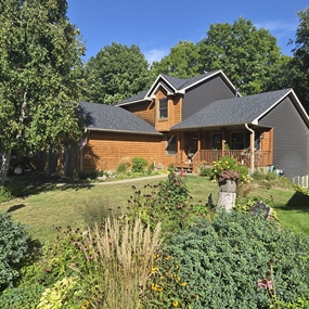 New roof installation on home surrounded by mature trees in Prior Lake